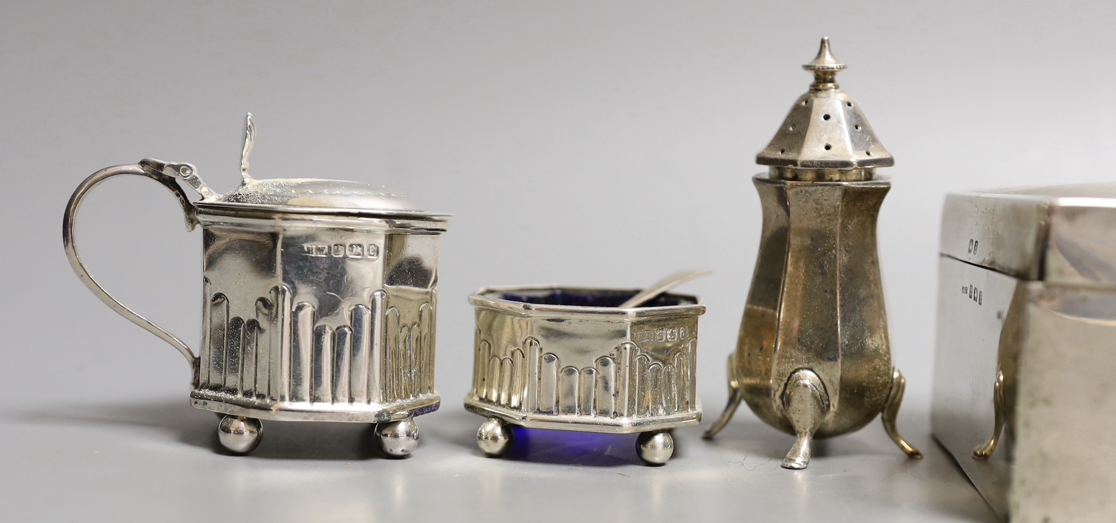 Six assorted silver condiments and a silver mounted cigarette box.